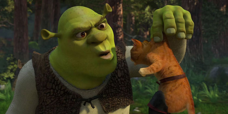 Shrek holding up Puss in Boots