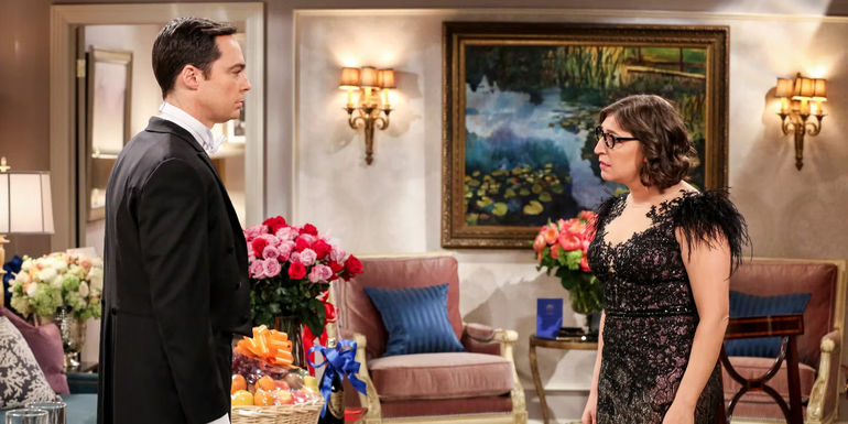 Sheldon and Amy dressed up and staring at each other in The Big Bang Theory