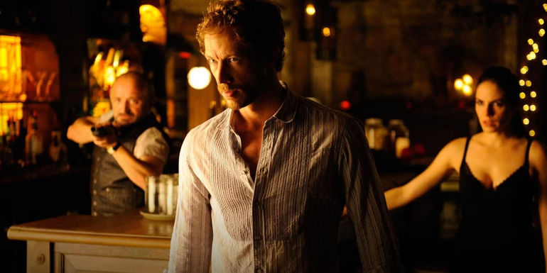Dyson (Kris Holden-Reid) glowers while Bo (Anna Silk) and Trick (Rick Howland) look on in Lost Girl