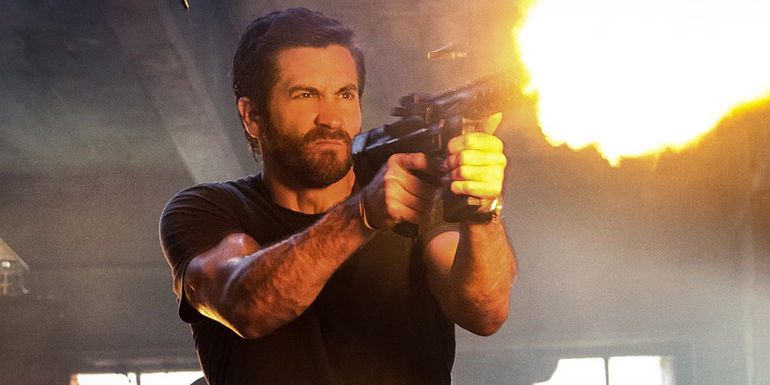 Jake Gyllenhaal firing a machine gun in Ambulance