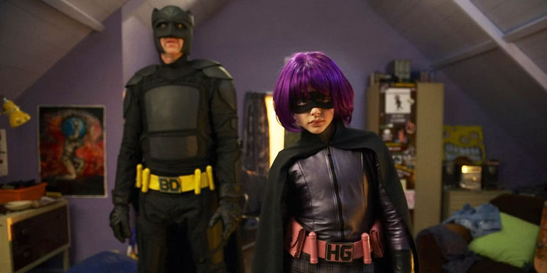 Big Daddy (Nicolas Cage) standing behind Hit-Girl (Chloë Grace Moretz) in Kick-Ass