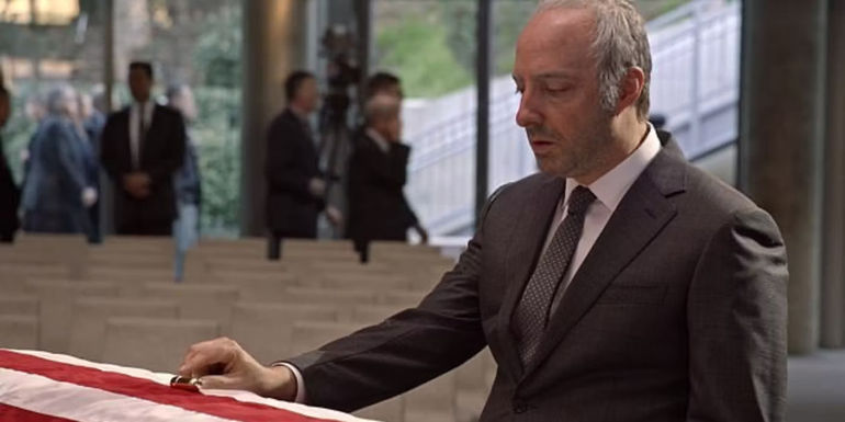 Gary places a tube of lipstick on Selina's coffin in Veep