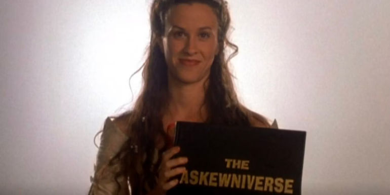 alanis morisette as god holding the book, titled the askewniverse