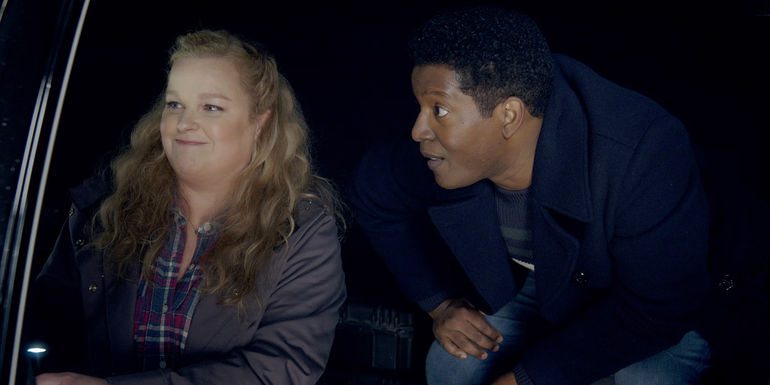 Elizabeth Bowen as Deputy Liv Bak next to Corey Reynolds as Sheriff Mike Thompson in Resident Alien season 3.