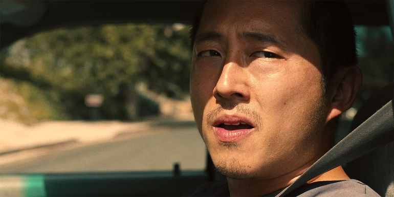 Danny (Steven Yeun) looks worried in his car in Beef