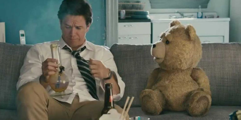 Mark Wahlberg holding a bong as grown up John Bennett sitting on the couch with Ted