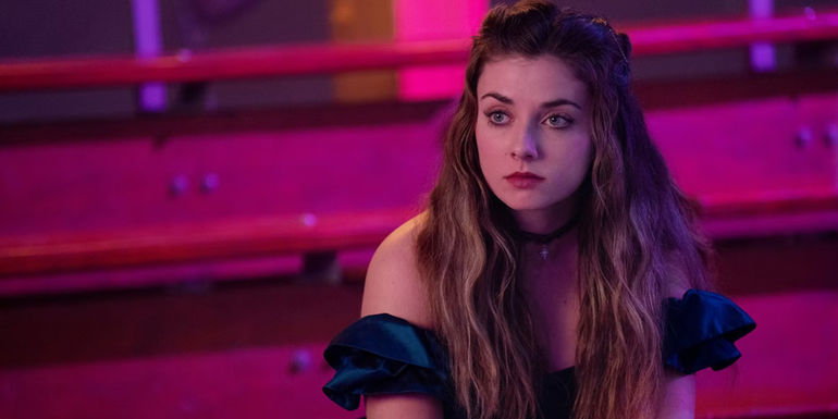 Giorgia Whigham looking serious in a prom dress as Blaire Bennett in Ted