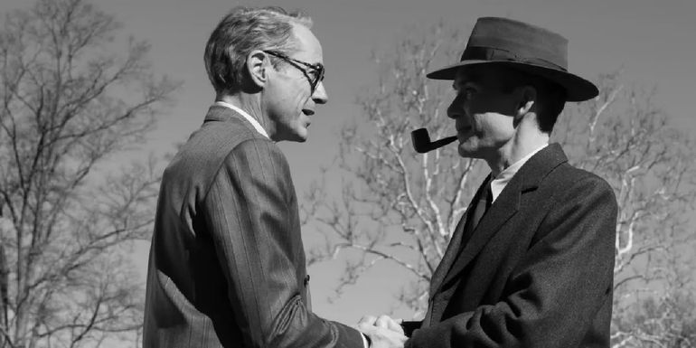Robert Downey Jr. as Strauss shakes hands with Cillian Murphy as J. Robert Oppenheimer in Oppenheimer.
