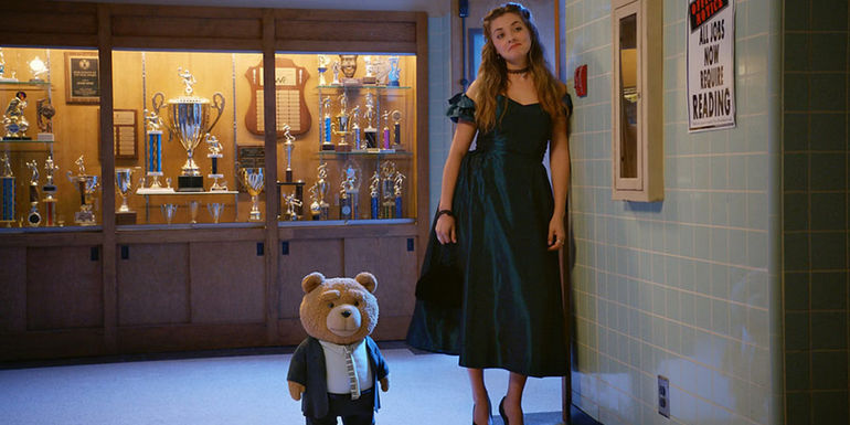 Ted and Blaire stand in the hallway at prom in Ted