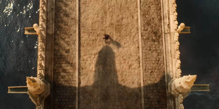The shadow of a dragon flying over a bridge in Netflix's Damsel