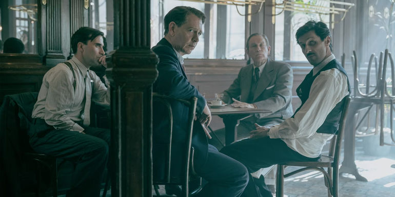 Christian Dior Sitting At A Table With A Group Of Designers In The New Look.jpg