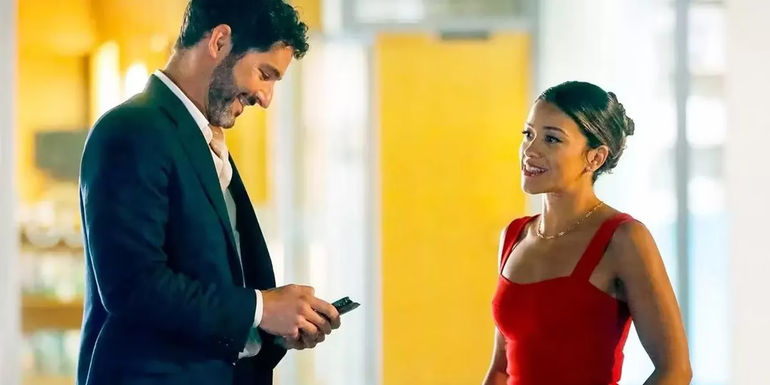 Nick looks at this phone and Mack looks at Nick in Players