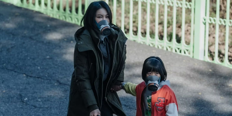 A woman and little girl wearing gas masks in Dark Hole