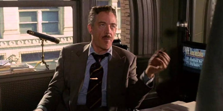 J K Simmons as J Jonah Jameson gesturing with a cigar and looking annoyed