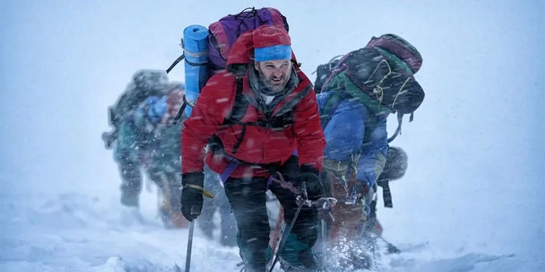 Men trekking through snowstorm 