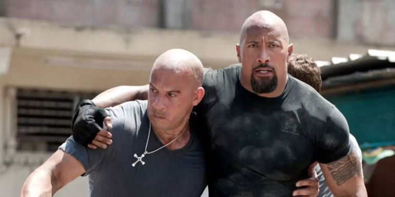 Dom (Vin Diesel) and Hobbs (Dwayne Johnson) carrying each other in Fast Five.