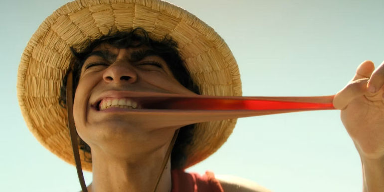 Iñaki Godoy as Monkey D. Luffy recreating Luffy's iconic introduction by stretching his cheek in Netflix's One Piece live-action show.