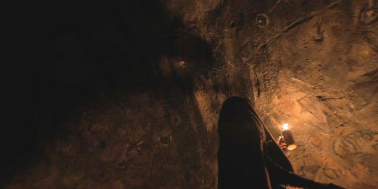 Kwan in the cave with the drawings in Halo season 2