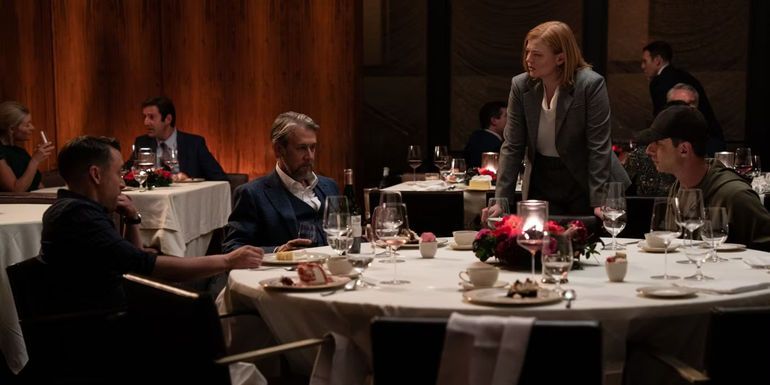 The Roy siblings sitting at an empty rehearsal table with Connor (Alan Ruck) looking sad in Succession season 4 episode 2.