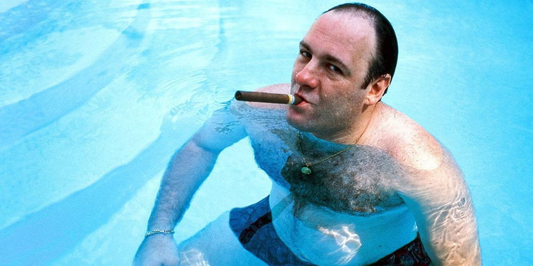 James Gandolfini as Tony smoking a cigar in his pool in The Sopranos