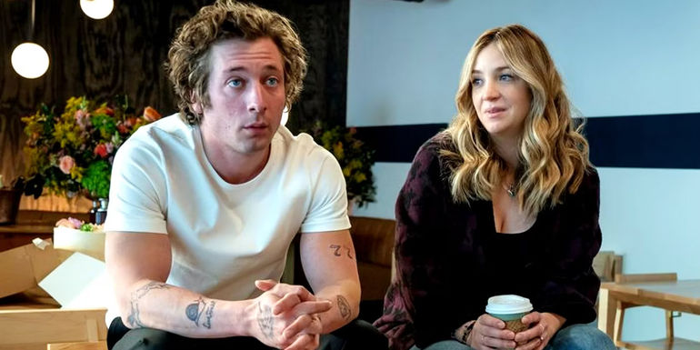 Carmy (Jeremy Allen White) looking ahead while Natalie (Abby Elliott) looks at him in The Bear season 2 finale.