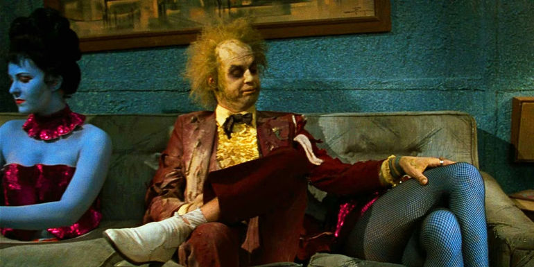 Beetlejuice (Michael Keaton) feels up dismembered legs in the Neitherworld waiting room at the end of Beetlejuice.