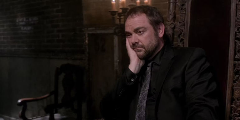Crowley Looking at Something in a Very Bored Way in Supernatural