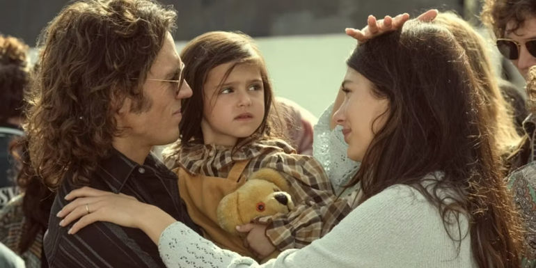 Daisy, Billy, and Julia embracing in Daisy Jones & the Six.