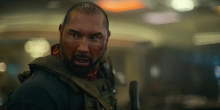 Dave Bautista looking over his shoulder, shocked, in Army of the Dead.