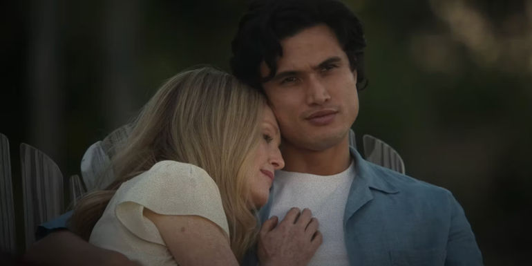Gracie (Julianne Moore) cuddling with Joe (Charles Melton) in May December.
