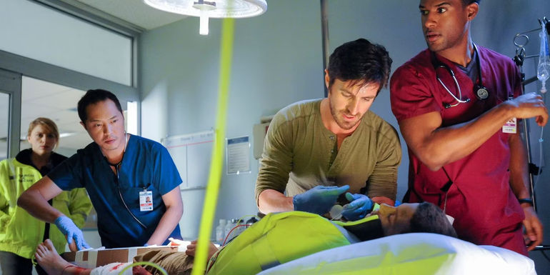 TC (Eoin Macken) and Topher (Ken Leung) working on a patient in The Night Shift.