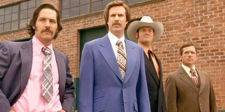 The Channel 4 news team standing and looking worried in Anchorman.