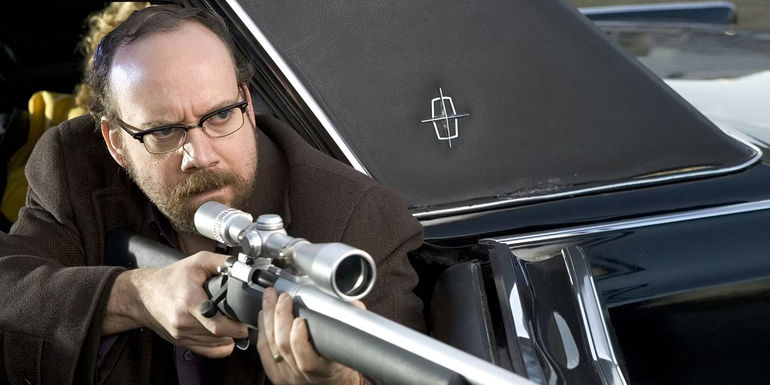 Paul Giamatti aiming a sniper rifle in Shoot 'Em up