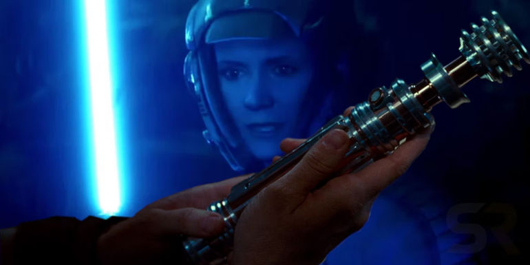 Leia stands holding her blue lightsaber in Rise of Skywalker in the background with a close-up of her lightsaber in the foreground