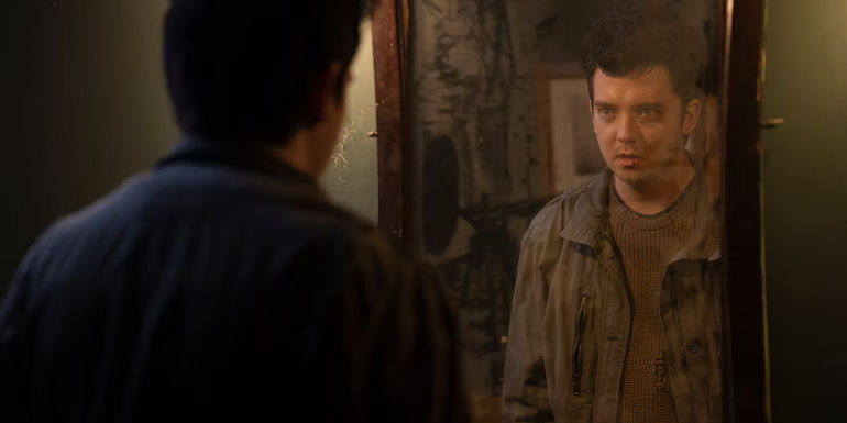 Asa Butterfield looking in a mirror in All Fun and Games