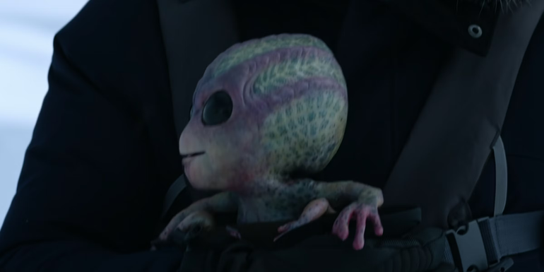 Harry holds his alien-human hybrid baby, Bridget, in Resident Alien