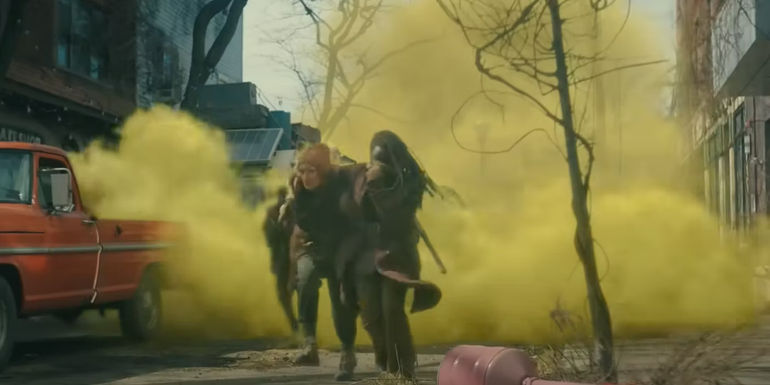 Michonne running from a CRM gas attack in The Walking Dead The Ones Who Live