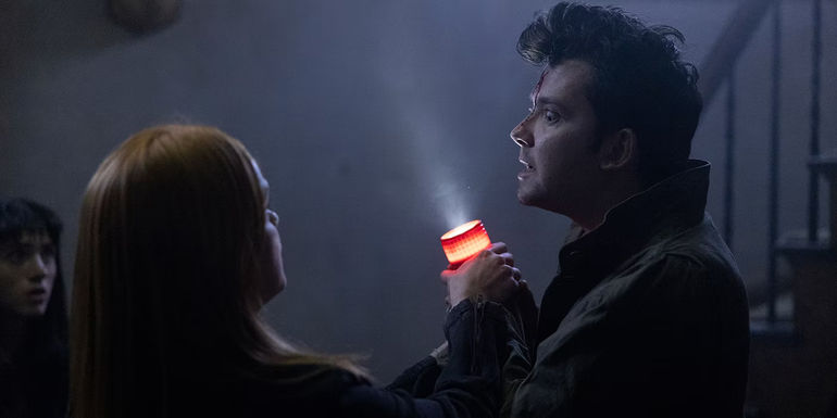 Natalia Dyer, Laurel Marsden and Asa Butterfield holding a flashlights in All Fun and Games