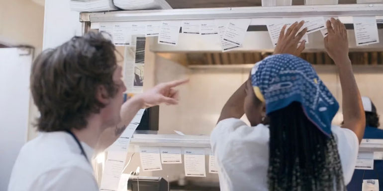 Carmy and Sydney organizing order receipts