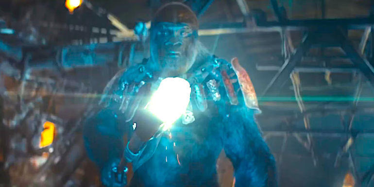 A gorilla soldier wields a long stick with a brightly glowing cattle prod-like device at one end in a dramatic scene from Kingdom of the Planet of the Apes