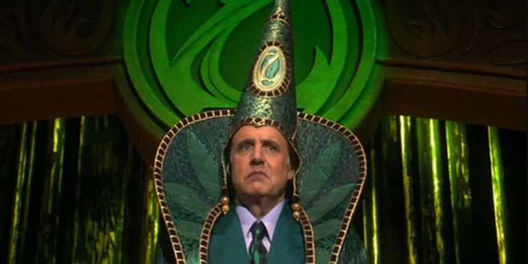 Jeffrey Tambor as the Wizard in full garb about to make announcements in The Muppets' Wizard of Oz