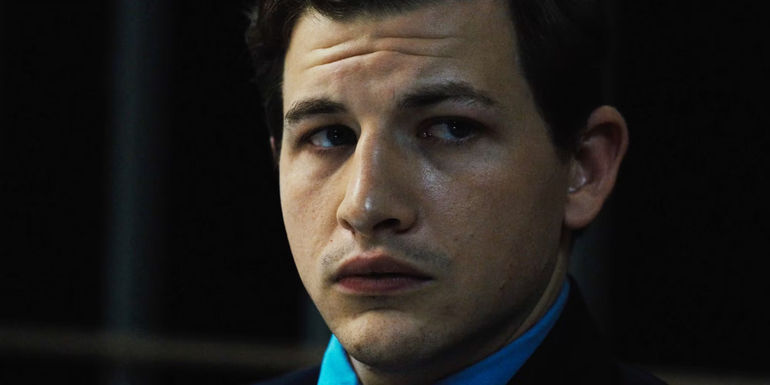 Tye Sheridan as Ollie Cross in a suit in Asphalt City