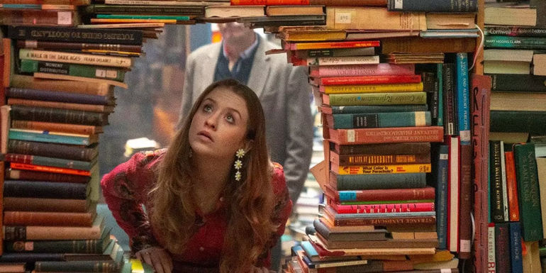Extraordinary season 2 Jen looking through stack of books that have been made into a circle