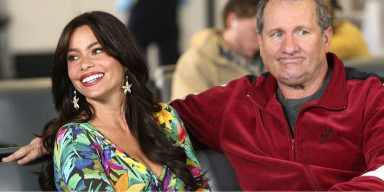 Sofía Vergara as Gloria and Ed O'Neill as Jay sit together on Modern Family.