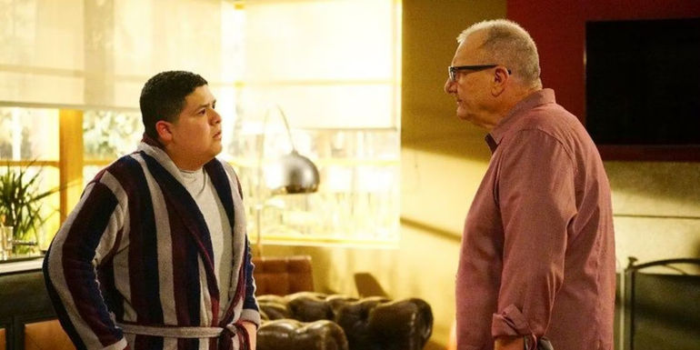Jay and Manny talking in the living room in Modern Family.