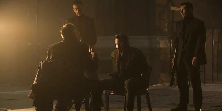 Keanu Reeves tied up while villains interrogate him in John Wick