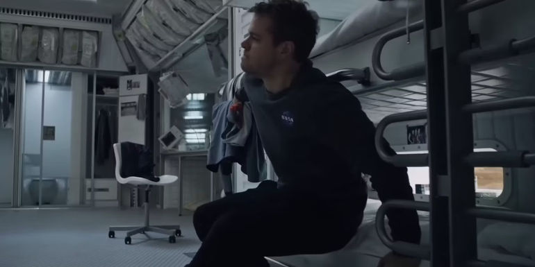 Mark Watney (Matt Damon) struggling to get out of bed in The Martian.