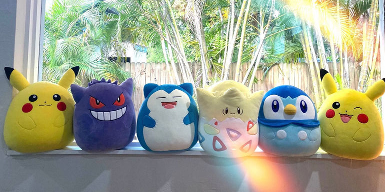 A photo of the full line of Pokemon Squishmallows so far, including Pikachu, Gengar, Snorlax, Togepi, Piplup, and Winking Pikachu.