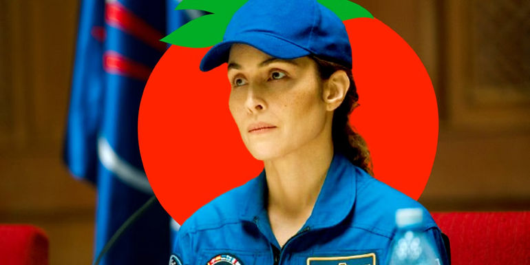 Noomi Rapace as Jo in Constellation with a Rotten Tomatoes logo behind her head - What critics dislike about Apple's new Sci-Fi and what audiences love. - Why Constellation's Rotten Tomatoes Critics & Audience Scores Are Divided