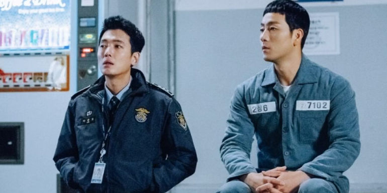 A guard and prisoner talk by the vending machines in Prison Playbook
